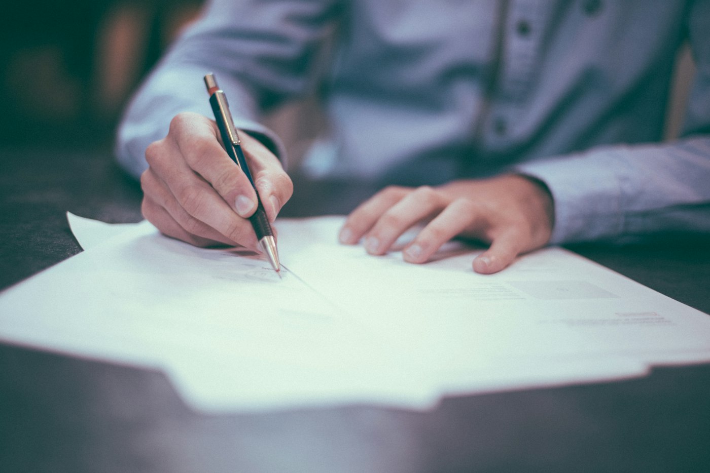 Documents and charts spread across a table during a review